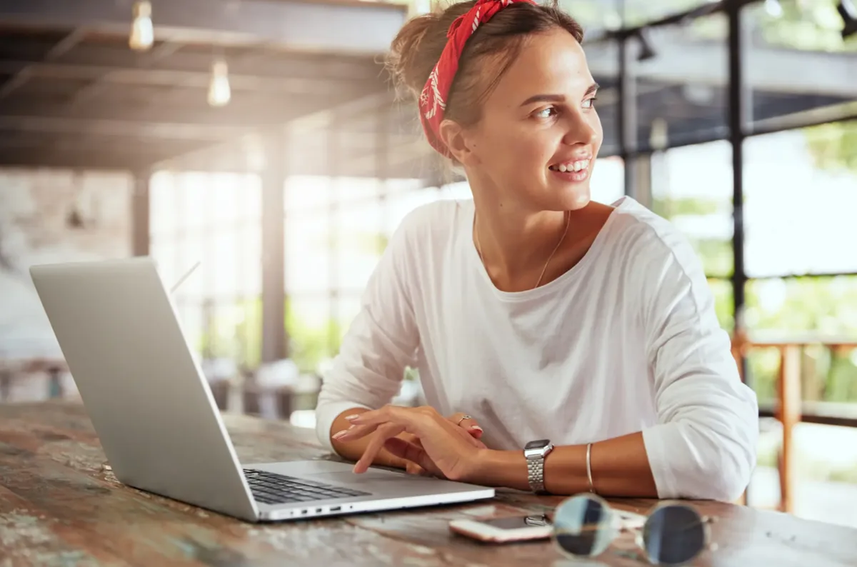 Une femme travaillant sur son ordinateur portable dans un café.